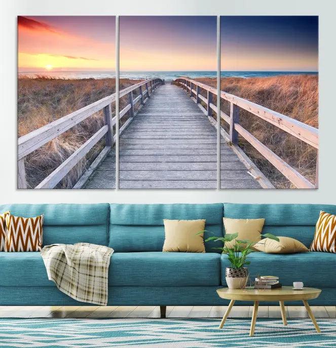 **Title:** Wooden Path at Baltic Sea Wall Art Canvas Print

**Description:** A triptych depicting a wooden boardwalk leading to a beach at sunset. This museum-quality canvas is ready to hang, offering an effortless enhancement to your decor.