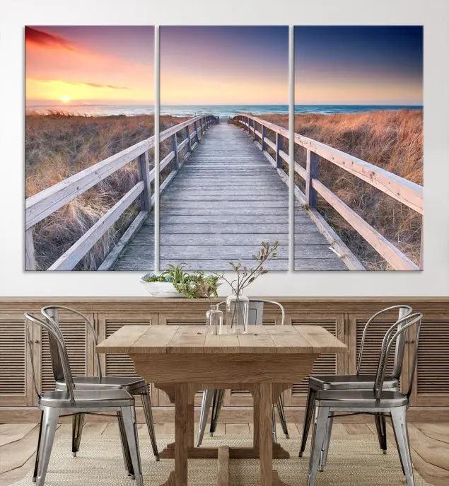 **Title:** Wooden Path at Baltic Sea Wall Art Canvas Print

**Description:** A triptych depicting a wooden boardwalk leading to a beach at sunset. This museum-quality canvas is ready to hang, offering an effortless enhancement to your decor.