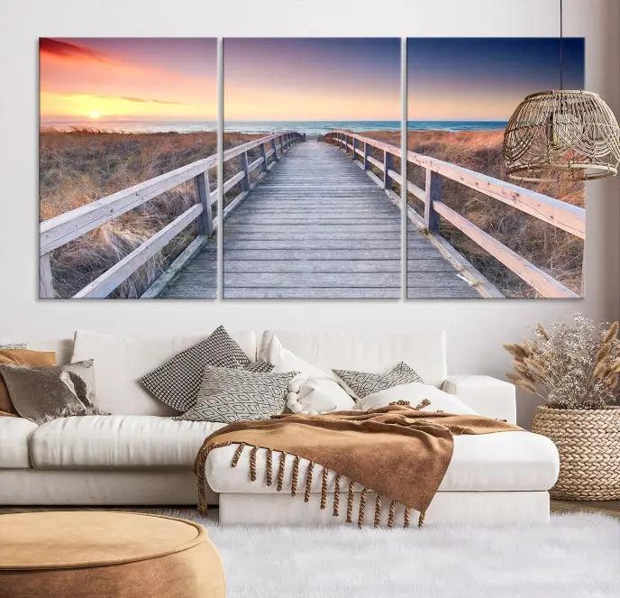 **Title:** Wooden Path at Baltic Sea Wall Art Canvas Print

**Description:** A triptych depicting a wooden boardwalk leading to a beach at sunset. This museum-quality canvas is ready to hang, offering an effortless enhancement to your decor.