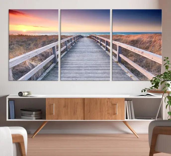 **Title:** Wooden Path at Baltic Sea Wall Art Canvas Print

**Description:** A triptych depicting a wooden boardwalk leading to a beach at sunset. This museum-quality canvas is ready to hang, offering an effortless enhancement to your decor.