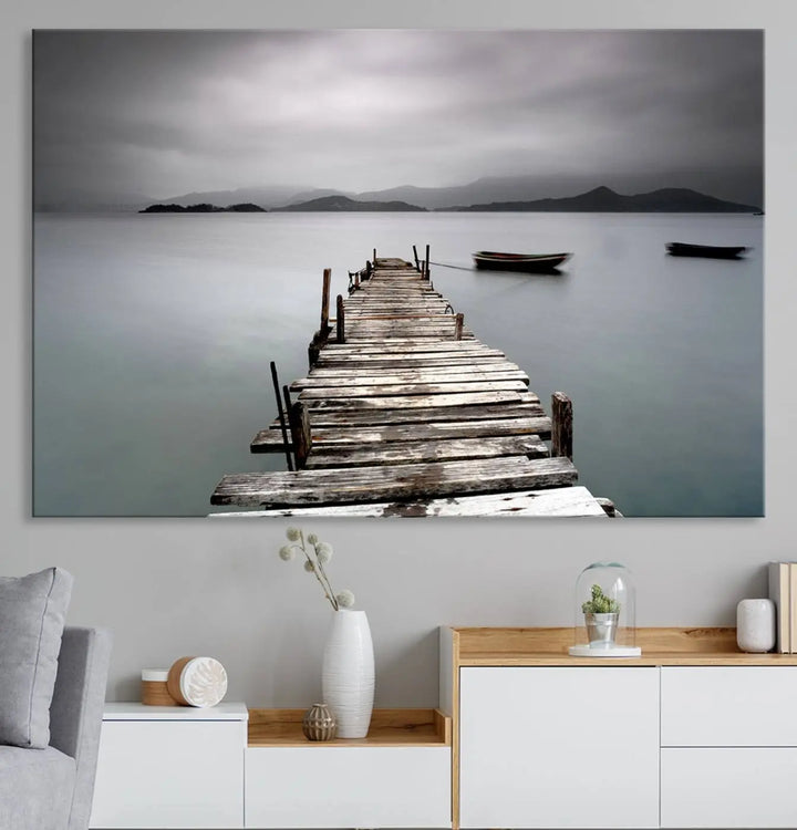 A serene triptych featuring a wooden pier stretching into misty waters brings the Wooden Pier Canvas Wall Art Beach Canvas Artwork Print to life.