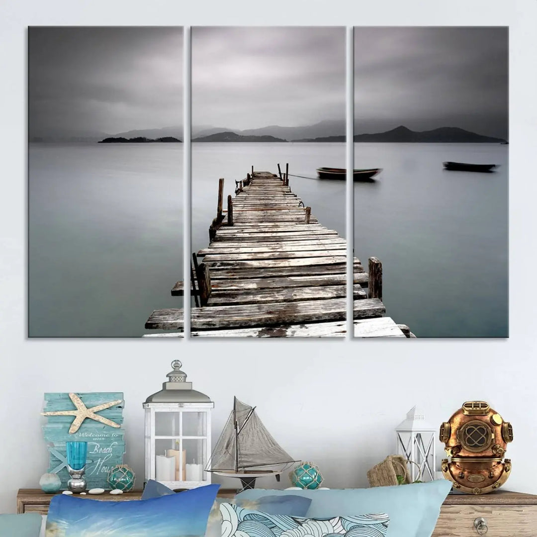 A serene triptych featuring a wooden pier stretching into misty waters brings the Wooden Pier Canvas Wall Art Beach Canvas Artwork Print to life.