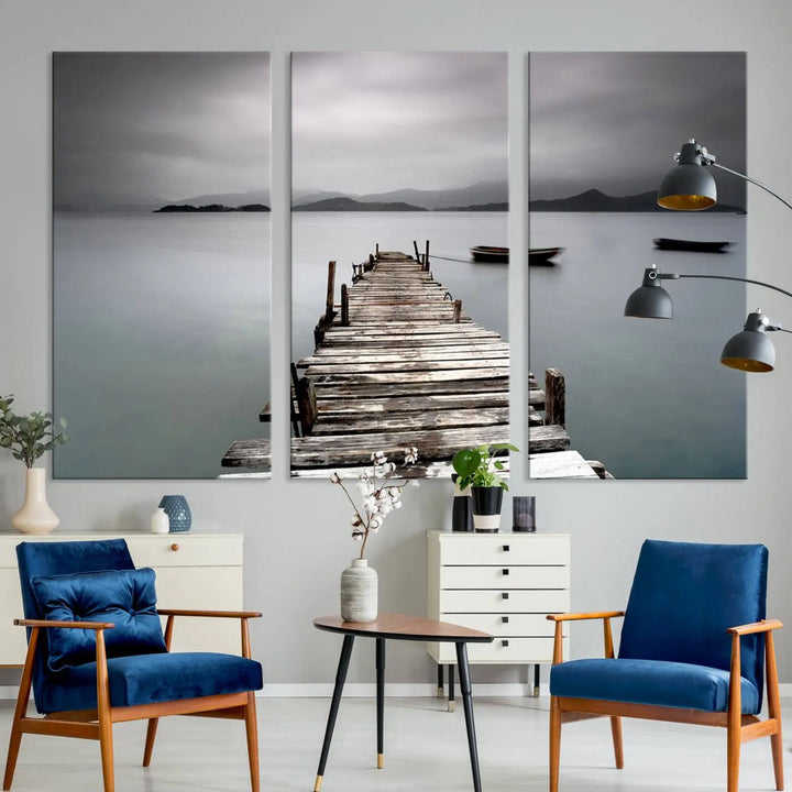 A serene triptych featuring a wooden pier stretching into misty waters brings the Wooden Pier Canvas Wall Art Beach Canvas Artwork Print to life.