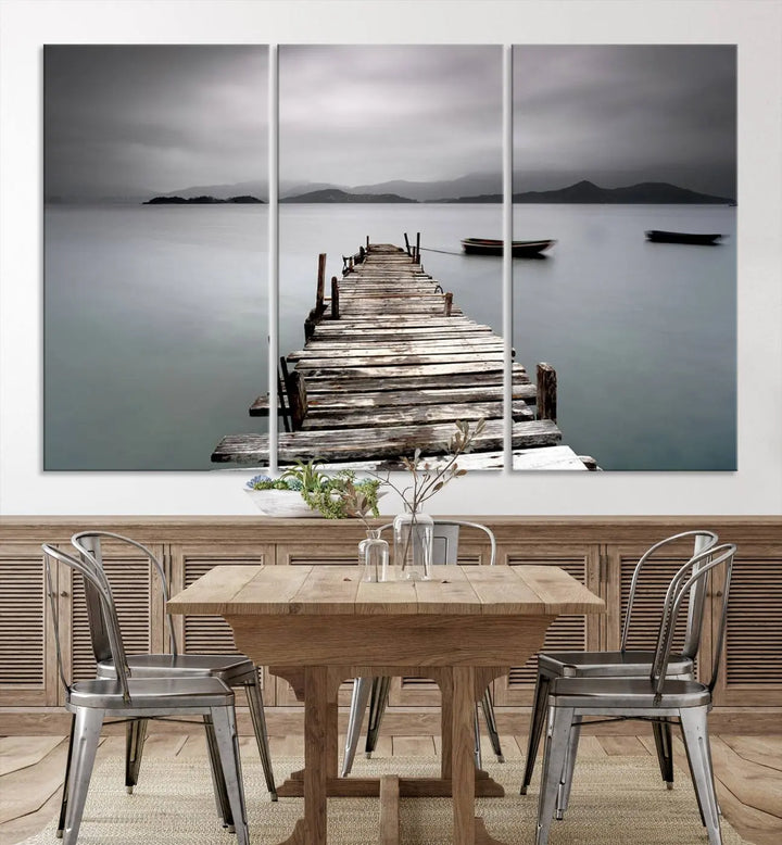 A serene triptych featuring a wooden pier stretching into misty waters brings the Wooden Pier Canvas Wall Art Beach Canvas Artwork Print to life.