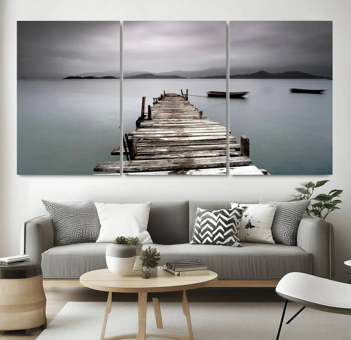 A serene triptych featuring a wooden pier stretching into misty waters brings the Wooden Pier Canvas Wall Art Beach Canvas Artwork Print to life.