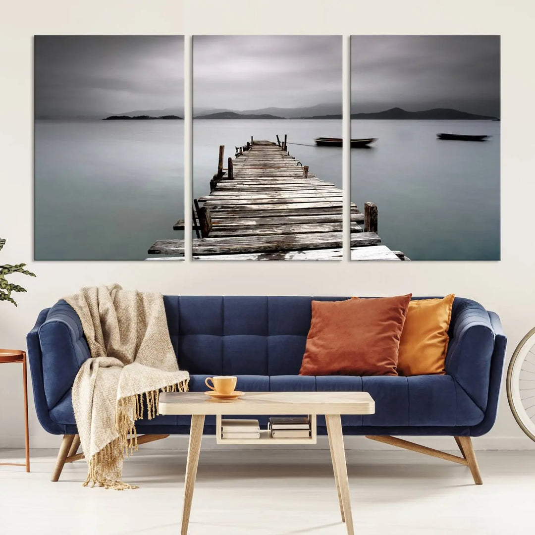 A serene triptych featuring a wooden pier stretching into misty waters brings the Wooden Pier Canvas Wall Art Beach Canvas Artwork Print to life.