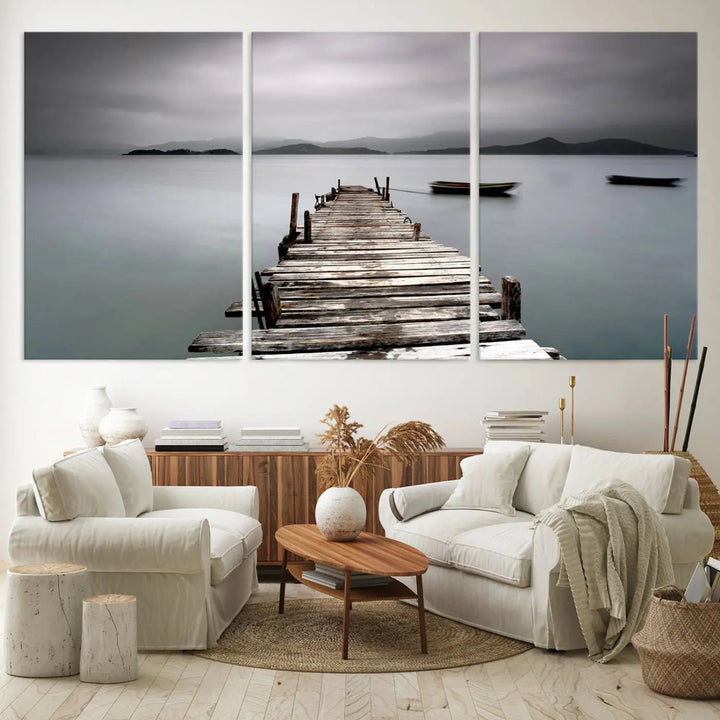 A serene triptych featuring a wooden pier stretching into misty waters brings the Wooden Pier Canvas Wall Art Beach Canvas Artwork Print to life.