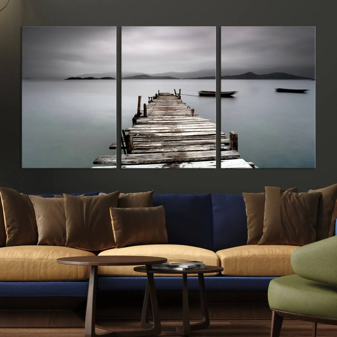 A serene triptych featuring a wooden pier stretching into misty waters brings the Wooden Pier Canvas Wall Art Beach Canvas Artwork Print to life.