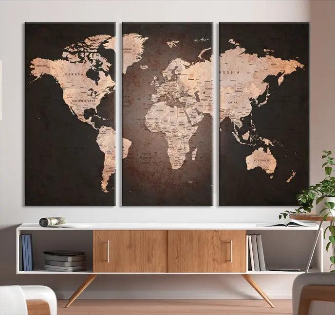 A World Map Canvas Print with a vintage design enhances the dark wall. This three-panel artwork is crafted on museum-quality canvases, gallery wrapped, and features a UV-protective coating for enduring brilliance.