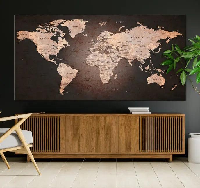 A World Map Canvas Print with a vintage design enhances the dark wall. This three-panel artwork is crafted on museum-quality canvases, gallery wrapped, and features a UV-protective coating for enduring brilliance.