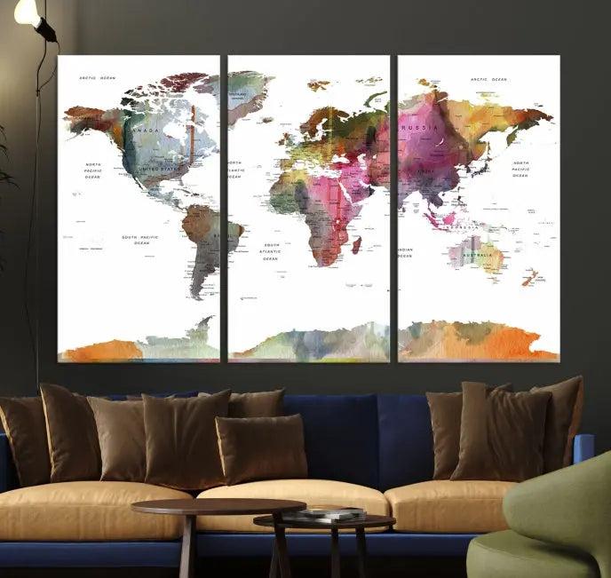 A set of three "World Map Push Pin Travel Canvas Prints" in vibrant colors adorns the dark wall.