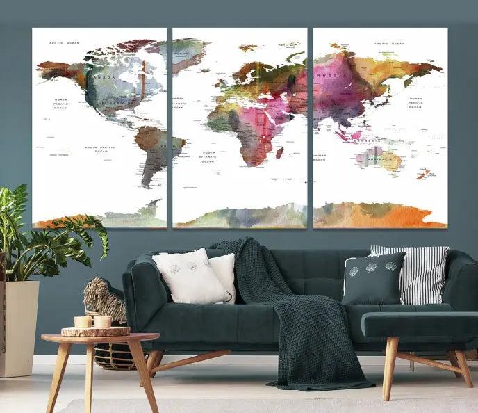 A set of three "World Map Push Pin Travel Canvas Prints" in vibrant colors adorns the dark wall.