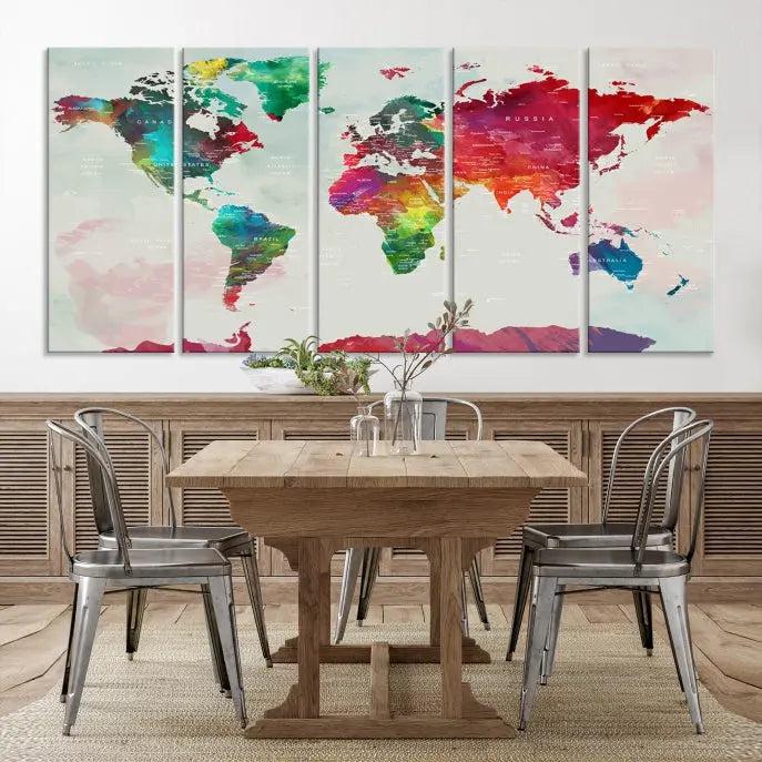 The World Map Wall Art, featuring a triptych design with vibrant continents, is printed on museum-quality canvases and displayed against a dark wall.