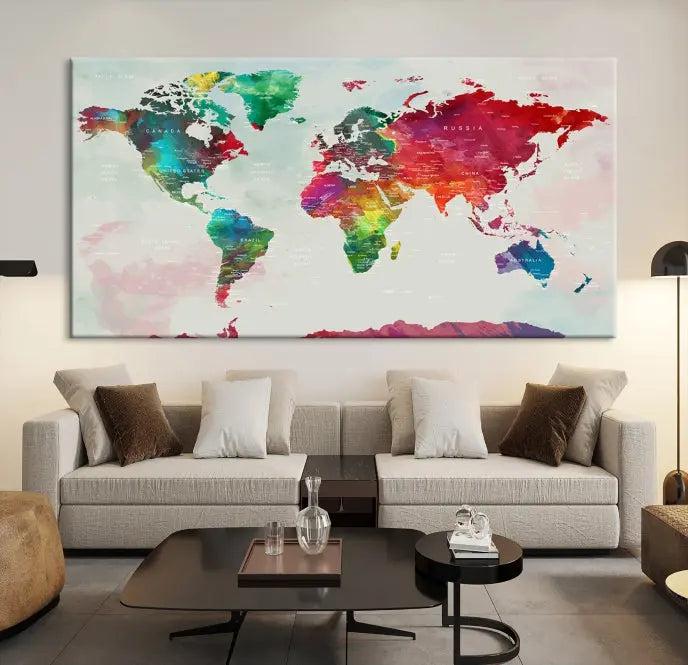 The World Map Wall Art, featuring a triptych design with vibrant continents, is printed on museum-quality canvases and displayed against a dark wall.