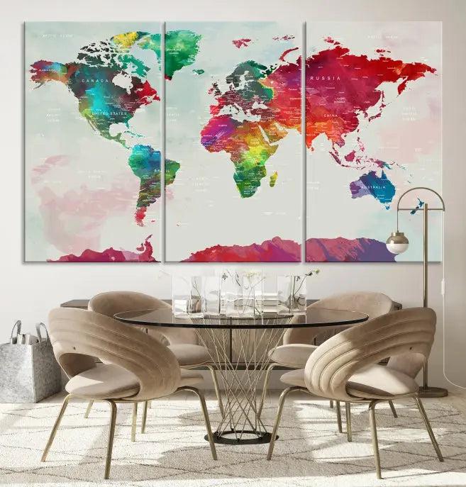 The World Map Wall Art, featuring a triptych design with vibrant continents, is printed on museum-quality canvases and displayed against a dark wall.