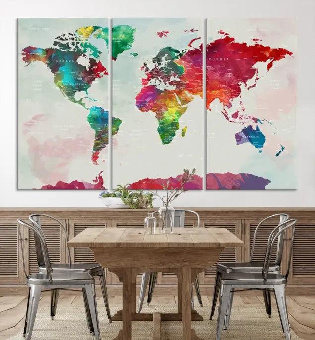 The World Map Wall Art, featuring a triptych design with vibrant continents, is printed on museum-quality canvases and displayed against a dark wall.