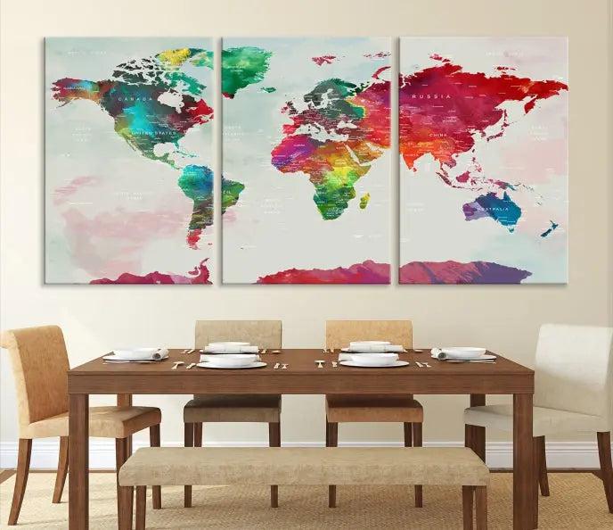 The World Map Wall Art, featuring a triptych design with vibrant continents, is printed on museum-quality canvases and displayed against a dark wall.