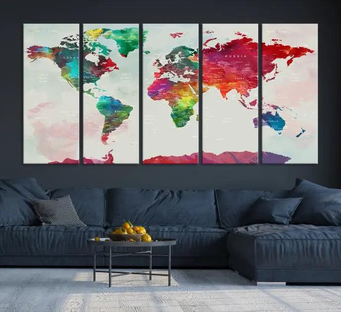 The World Map Wall Art, featuring a triptych design with vibrant continents, is printed on museum-quality canvases and displayed against a dark wall.