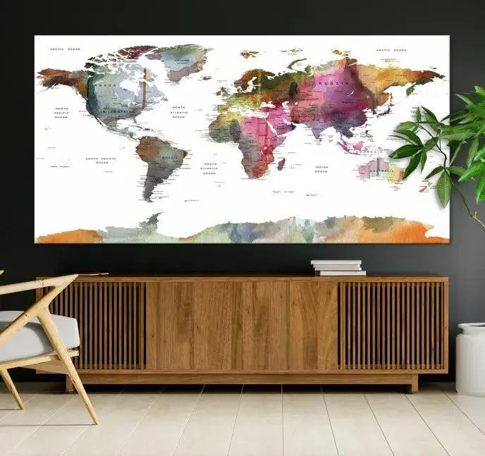 The wall is adorned with a three-panel World Map Wall Art Canvas Print. These museum-quality canvases are gallery wrapped for an elegant finish, and their UV-protective coating ensures the vibrant details will be preserved for years to come.