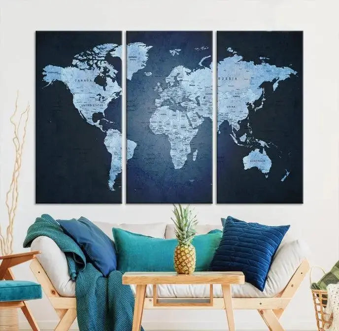 A modern living room featuring a World Map Wall Art Canvas Print in triptych format.