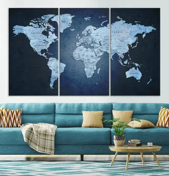 A modern living room featuring a World Map Wall Art Canvas Print in triptych format.