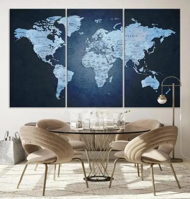 A modern living room featuring a World Map Wall Art Canvas Print in triptych format.