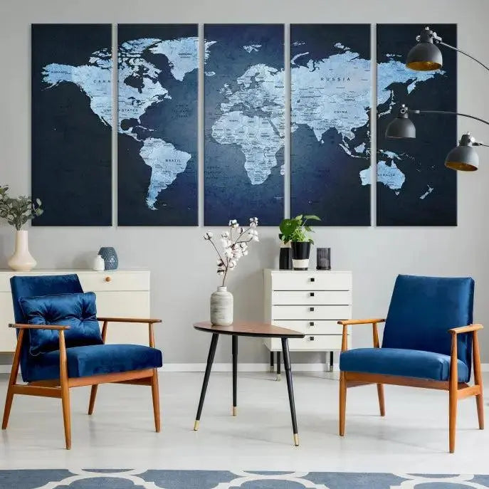 A modern living room featuring a World Map Wall Art Canvas Print in triptych format.