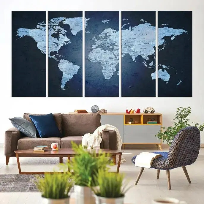 A modern living room featuring a World Map Wall Art Canvas Print in triptych format.