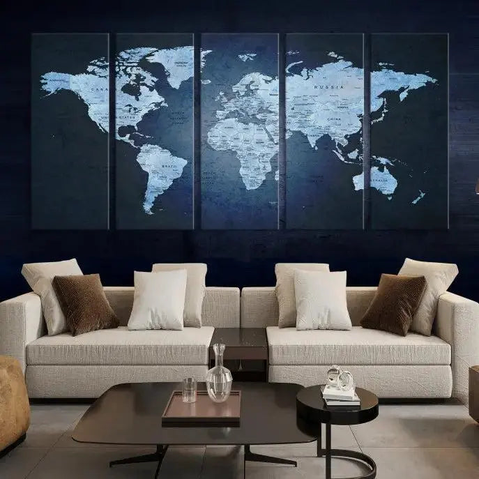 A modern living room featuring a World Map Wall Art Canvas Print in triptych format.