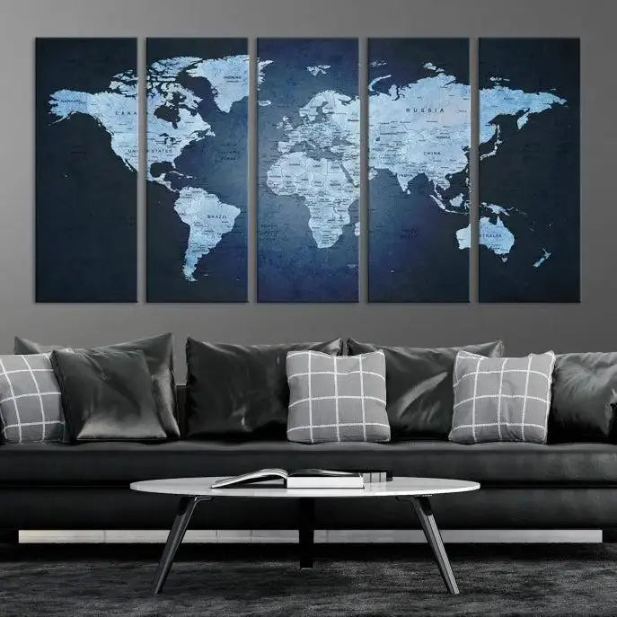 A modern living room featuring a World Map Wall Art Canvas Print in triptych format.