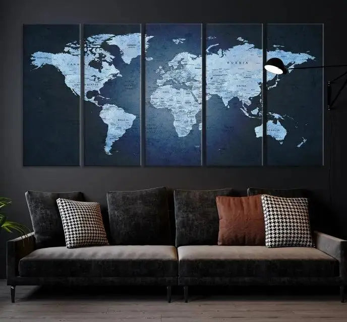 A modern living room featuring a World Map Wall Art Canvas Print in triptych format.