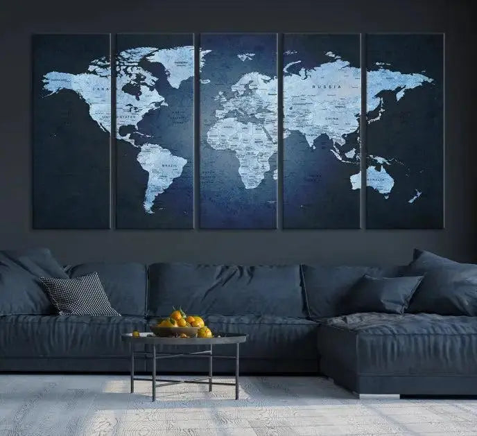 A modern living room featuring a World Map Wall Art Canvas Print in triptych format.