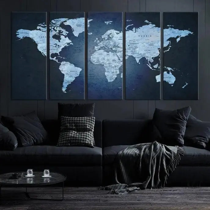 A modern living room featuring a World Map Wall Art Canvas Print in triptych format.