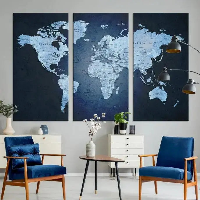 A modern living room featuring a World Map Wall Art Canvas Print in triptych format.