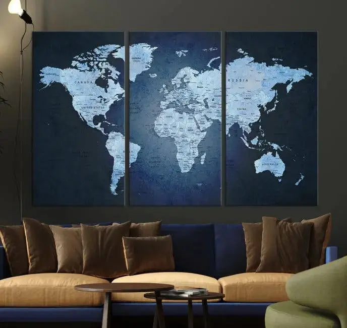 A modern living room featuring a World Map Wall Art Canvas Print in triptych format.