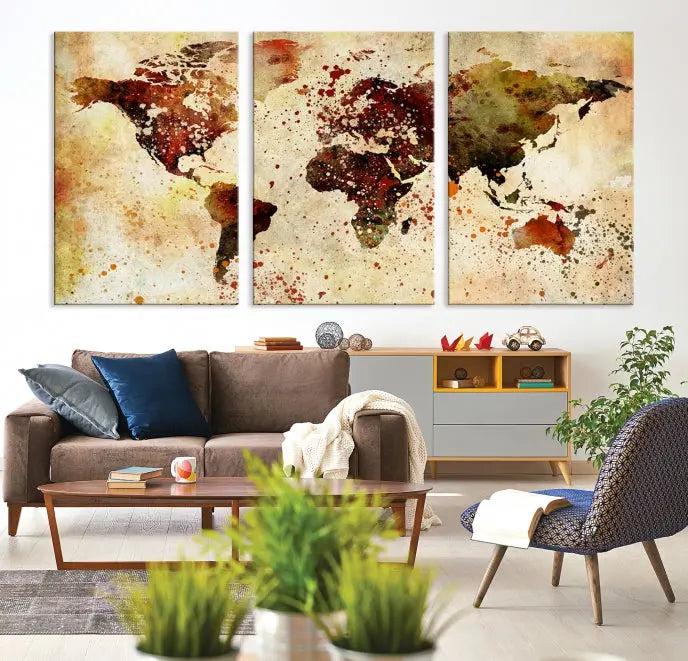 The World Map Wall Art Canvas Print, gallery-wrapped on museum-quality canvas adorned with watercolor splatters, enhances a modern living room decor. This artwork features a UV-protective coating to maintain its vibrant colors and elegant appearance over time.