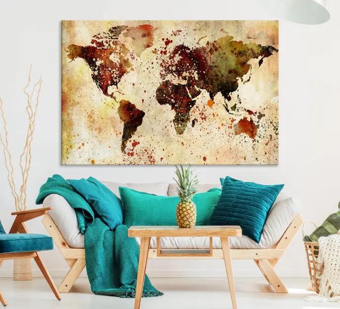 The World Map Wall Art Canvas Print, gallery-wrapped on museum-quality canvas adorned with watercolor splatters, enhances a modern living room decor. This artwork features a UV-protective coating to maintain its vibrant colors and elegant appearance over time.