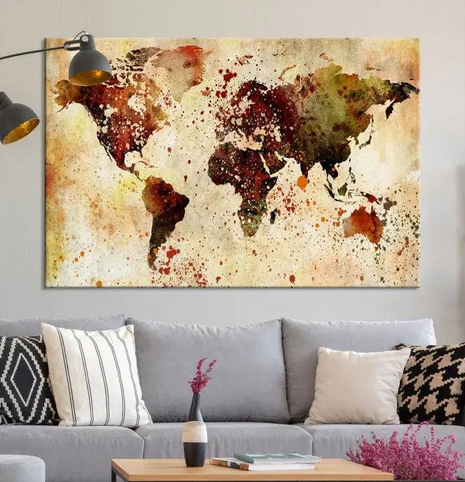 The World Map Wall Art Canvas Print, gallery-wrapped on museum-quality canvas adorned with watercolor splatters, enhances a modern living room decor. This artwork features a UV-protective coating to maintain its vibrant colors and elegant appearance over time.