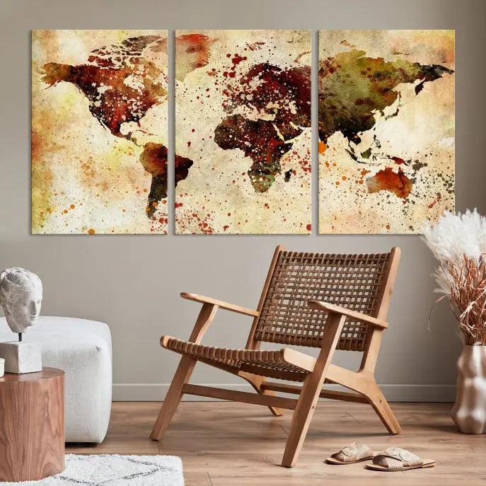 The World Map Wall Art Canvas Print, gallery-wrapped on museum-quality canvas adorned with watercolor splatters, enhances a modern living room decor. This artwork features a UV-protective coating to maintain its vibrant colors and elegant appearance over time.