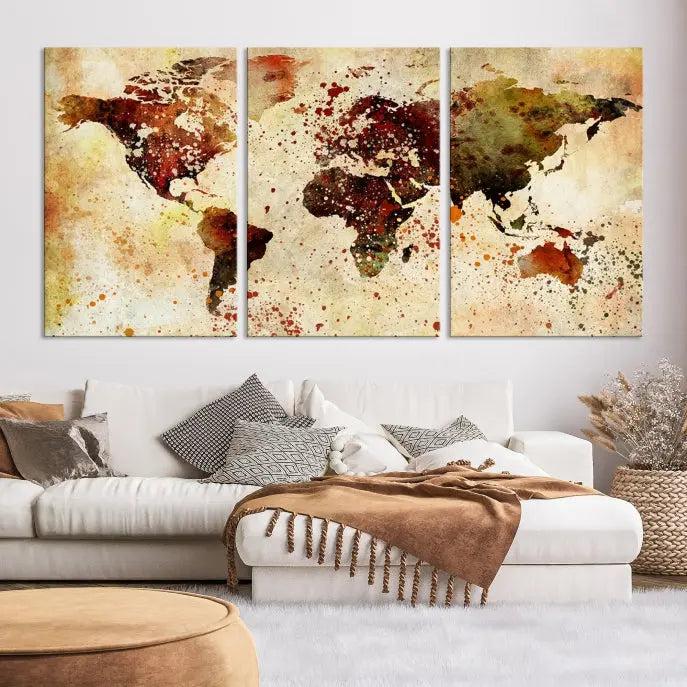 The World Map Wall Art Canvas Print, gallery-wrapped on museum-quality canvas adorned with watercolor splatters, enhances a modern living room decor. This artwork features a UV-protective coating to maintain its vibrant colors and elegant appearance over time.