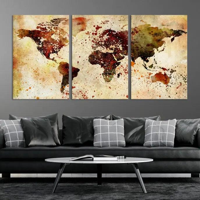 The World Map Wall Art Canvas Print, gallery-wrapped on museum-quality canvas adorned with watercolor splatters, enhances a modern living room decor. This artwork features a UV-protective coating to maintain its vibrant colors and elegant appearance over time.