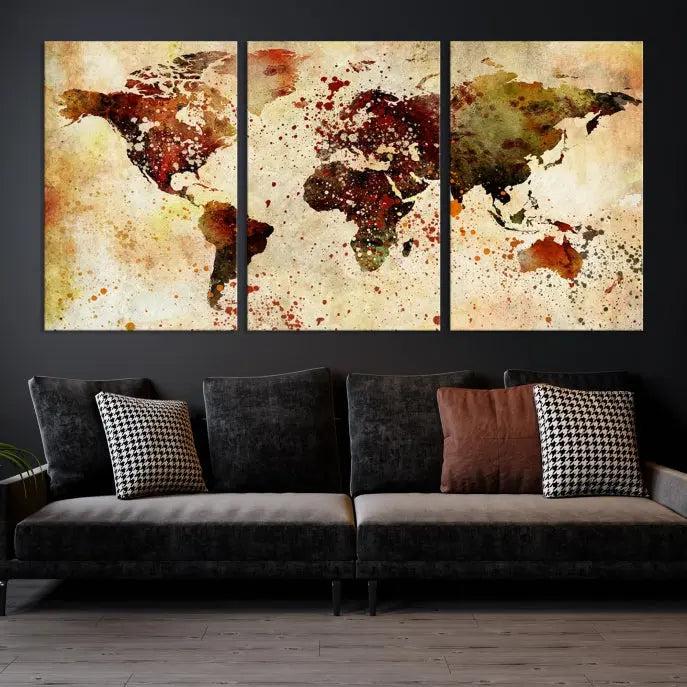 The World Map Wall Art Canvas Print, gallery-wrapped on museum-quality canvas adorned with watercolor splatters, enhances a modern living room decor. This artwork features a UV-protective coating to maintain its vibrant colors and elegant appearance over time.