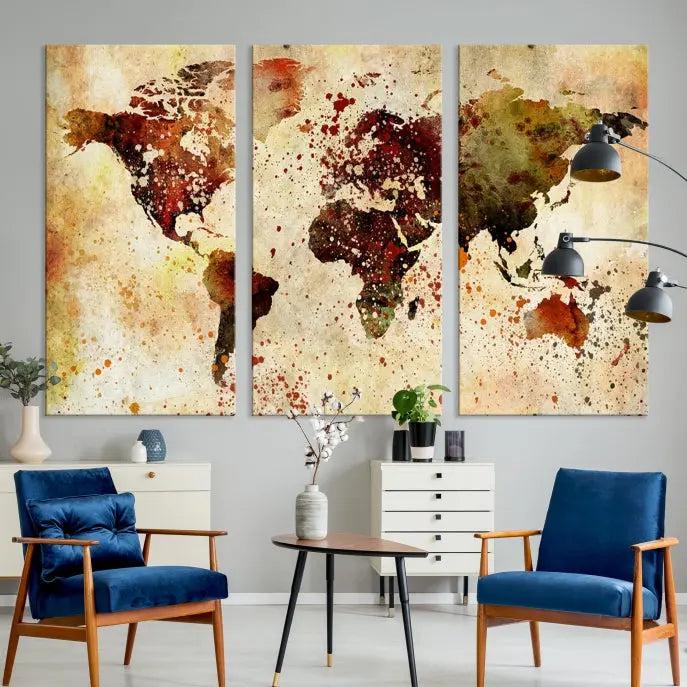 The World Map Wall Art Canvas Print, gallery-wrapped on museum-quality canvas adorned with watercolor splatters, enhances a modern living room decor. This artwork features a UV-protective coating to maintain its vibrant colors and elegant appearance over time.