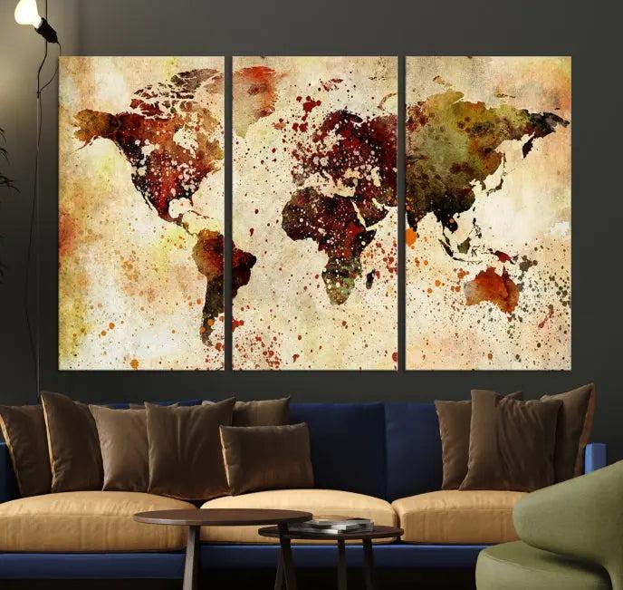 The World Map Wall Art Canvas Print, gallery-wrapped on museum-quality canvas adorned with watercolor splatters, enhances a modern living room decor. This artwork features a UV-protective coating to maintain its vibrant colors and elegant appearance over time.