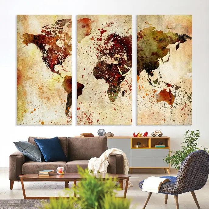 The World Map Wall Art Canvas Print, gallery-wrapped on museum-quality canvas adorned with watercolor splatters, enhances a modern living room decor. This artwork features a UV-protective coating to maintain its vibrant colors and elegant appearance over time.