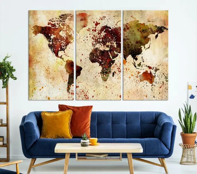 The World Map Wall Art Canvas Print, gallery-wrapped on museum-quality canvas adorned with watercolor splatters, enhances a modern living room decor. This artwork features a UV-protective coating to maintain its vibrant colors and elegant appearance over time.