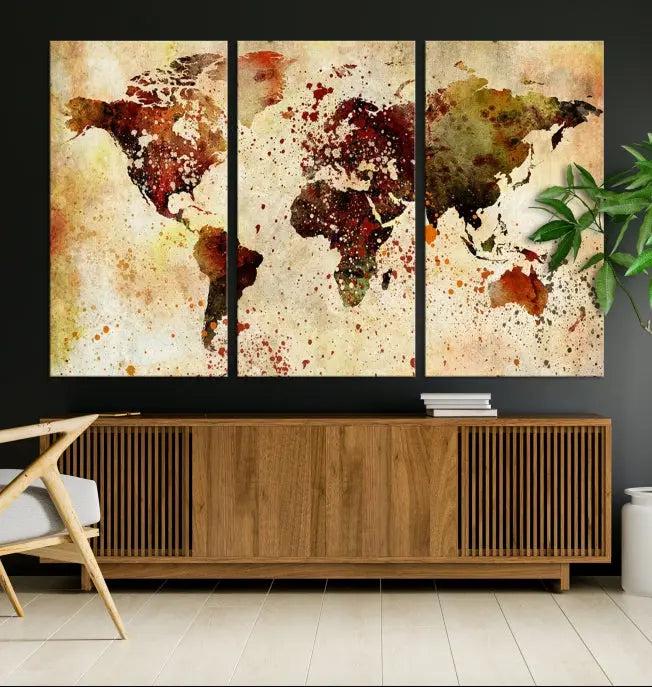 The World Map Wall Art Canvas Print, gallery-wrapped on museum-quality canvas adorned with watercolor splatters, enhances a modern living room decor. This artwork features a UV-protective coating to maintain its vibrant colors and elegant appearance over time.