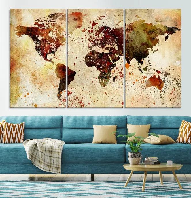 The World Map Wall Art Canvas Print, gallery-wrapped on museum-quality canvas adorned with watercolor splatters, enhances a modern living room decor. This artwork features a UV-protective coating to maintain its vibrant colors and elegant appearance over time.