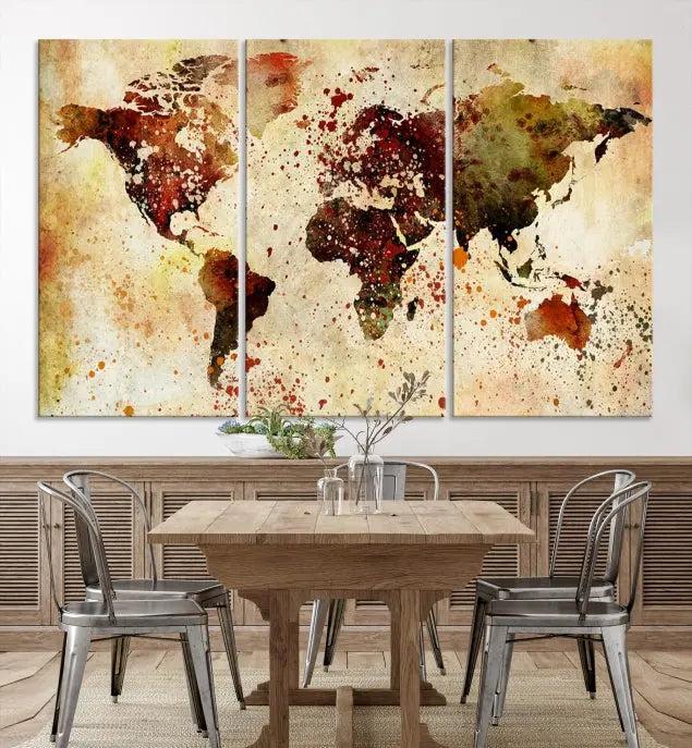 The World Map Wall Art Canvas Print, gallery-wrapped on museum-quality canvas adorned with watercolor splatters, enhances a modern living room decor. This artwork features a UV-protective coating to maintain its vibrant colors and elegant appearance over time.