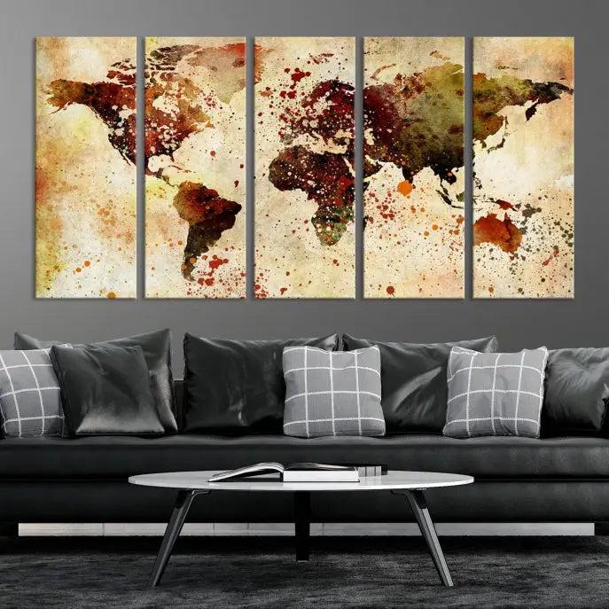 The World Map Wall Art Canvas Print, gallery-wrapped on museum-quality canvas adorned with watercolor splatters, enhances a modern living room decor. This artwork features a UV-protective coating to maintain its vibrant colors and elegant appearance over time.